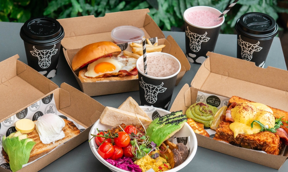 A photo of a family meal pack. It includes two adult meals, two kids meals, two kids milkshakes and two delicious coffees.