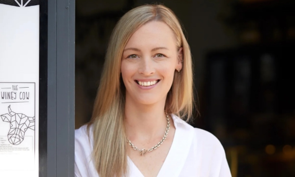 A photo of The Winey Cow in Mornington's owner, Jill Henderson, wearing a white top and smiling directly into the camera.