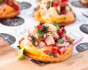 Indulge in The Winey Cow's fresh and vibrant appetizer featuring a crispy base topped with a flavorful blend of diced seafood, herbs, and a touch of creamy sauce, creating a delightful burst of taste in every bite.