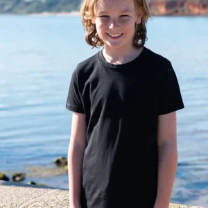 A young boy with a black t-shirt by the water side.