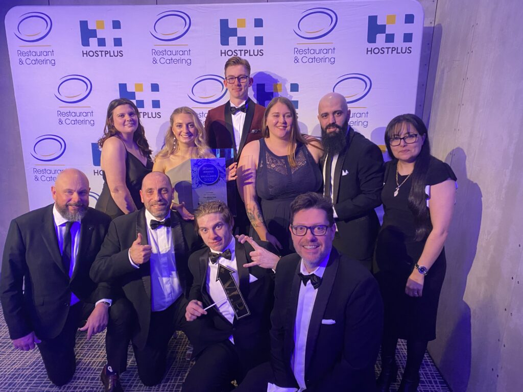 A photo of a group of smiling staff members who have just received the Restaurant & Catering Association's Award for Excellence in the category Brunch Restaurant.