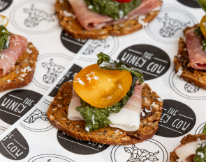 A colourful canape of proscuitto, tomato and pesto on a crostini from the catering menu in Mornington.